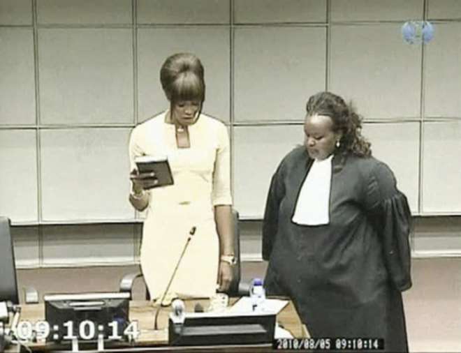 A frame grab shows British supermodel Naomi Campbell (L) taking an oath before testifying at the war crimes trial of former Liberian President Charles Taylor at the U.N. Special Court for Sierra Leone in Leidschendam August 5, 2010. Campbell said on Thurs
