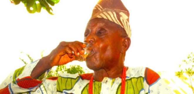 Chief Moses Enimade the Oyewoga of Ireleland drinking after pouring libation