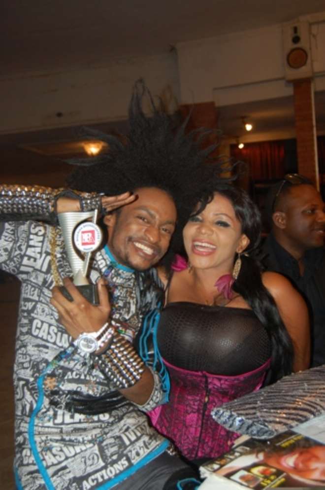 DENRELE DISPLAY HIS AWARD WITH COSSY