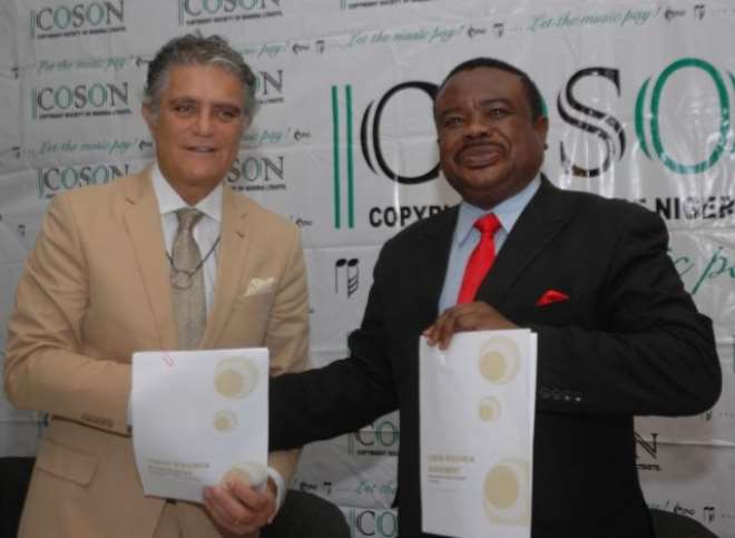 Eng Moussalli and Chief Okoroji displaying the signed royalty agreement documents in Lagos