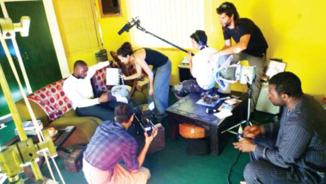 Setting up a shot during the filming of ‘Aina’

