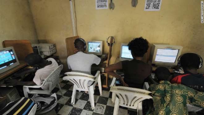 Young Africans browsing the internet in a cybercafe in Ivory Coast