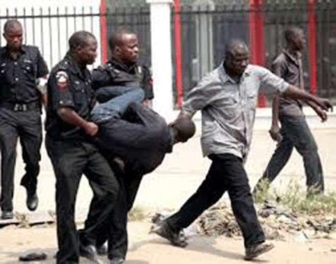 FILE PHOTO: A suspected offender being forcefully arrested by policemen