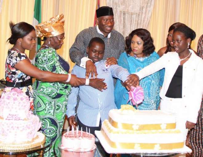 Dame Patience Jonathan being supported by her children with President Goodluck Jonathan; his mum, Mama Eunice Jonathan (2l); to cut her cake during a family get-together to mark the first Lady’s 55th Birthday at the State House, Abuja