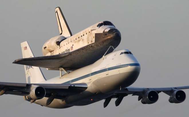 The space shuttle Discovery piggybacked on a modified jumbo jet as it made its final flight. Photo: Reuters