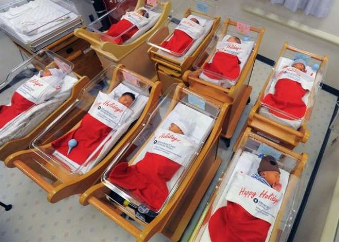 Newborns sleep in oversized red stockings in the nursery at Long Beach Memorial in Long Beach, Calif., on Monday. For more than 50 years, babies born between December 21-25 at Long Beach Memorial are placed in big red stockings to be presented to the new 