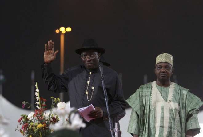 Nigeria's president Goodluck Jonathan (L) addresses delegates next to vice-president Namadi Sambo during the primaries